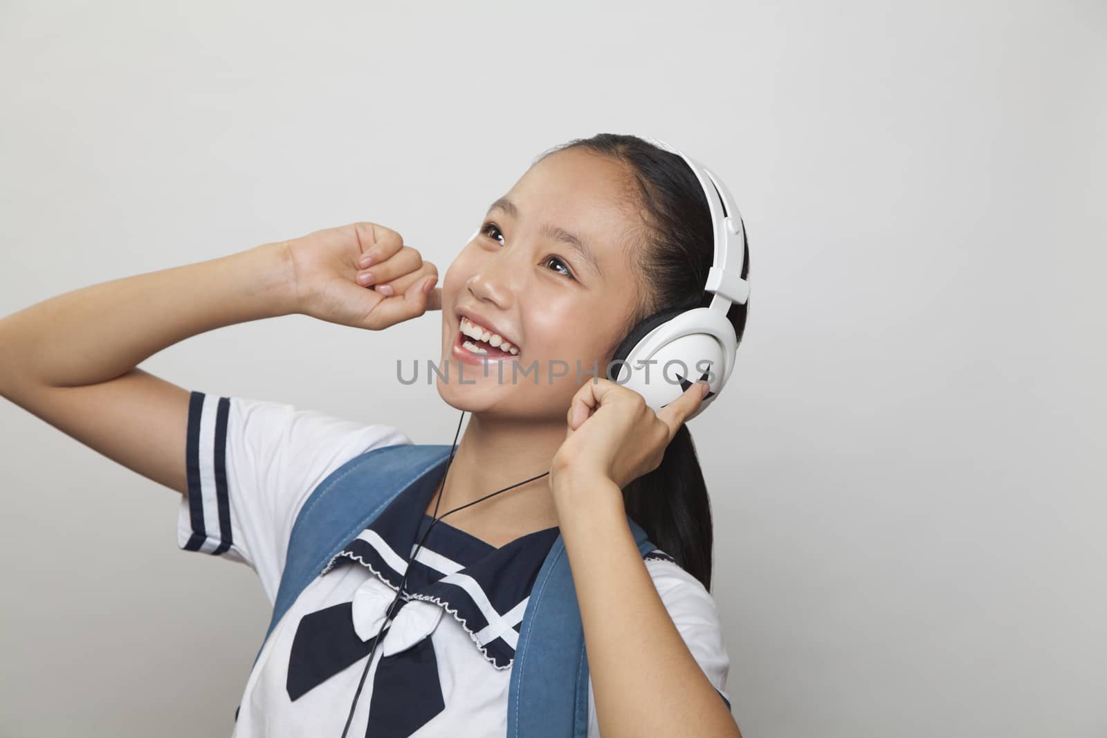 Girl smiling and listening to music, Studio
