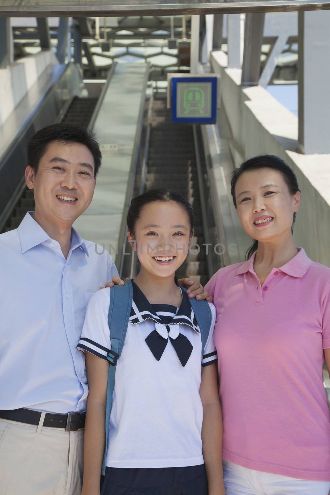 Family standing next to the escalator near the subway station