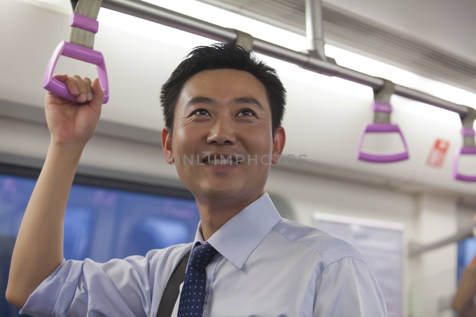 Businessman smiling in the subway