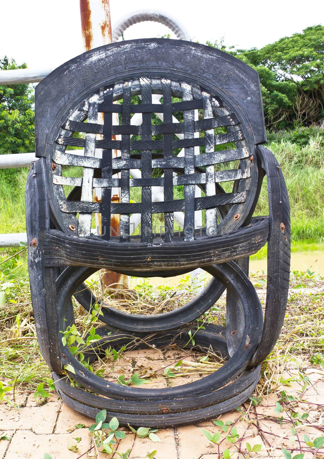 old chair beside the iron fence by sutipp11