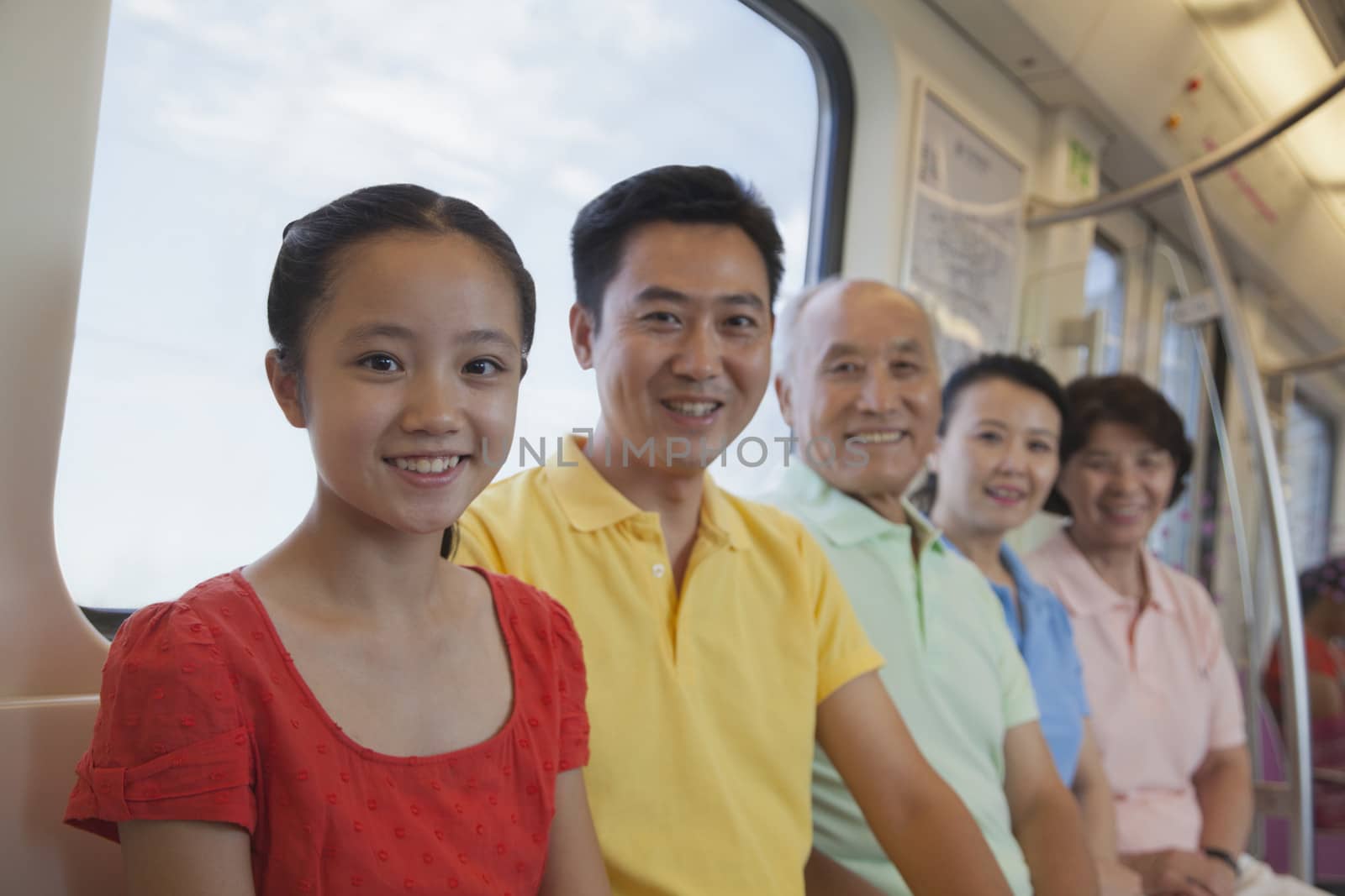 Family sitting in the subway, portrait