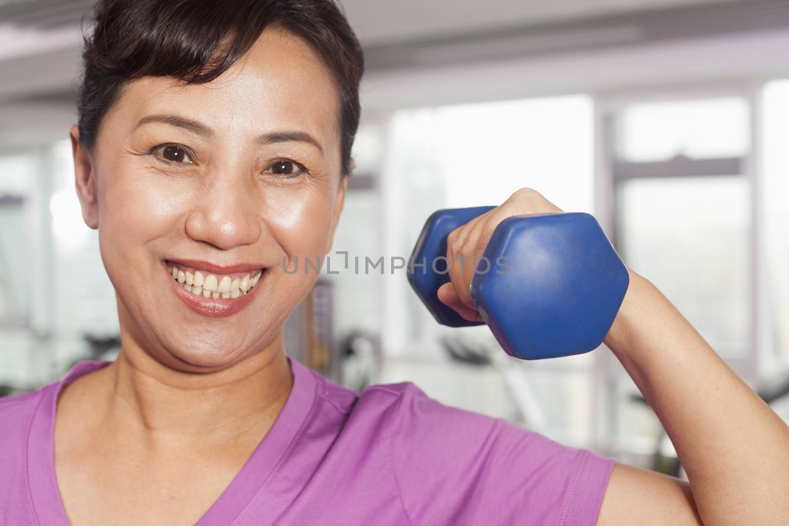 Woman exercising with weights by XiXinXing