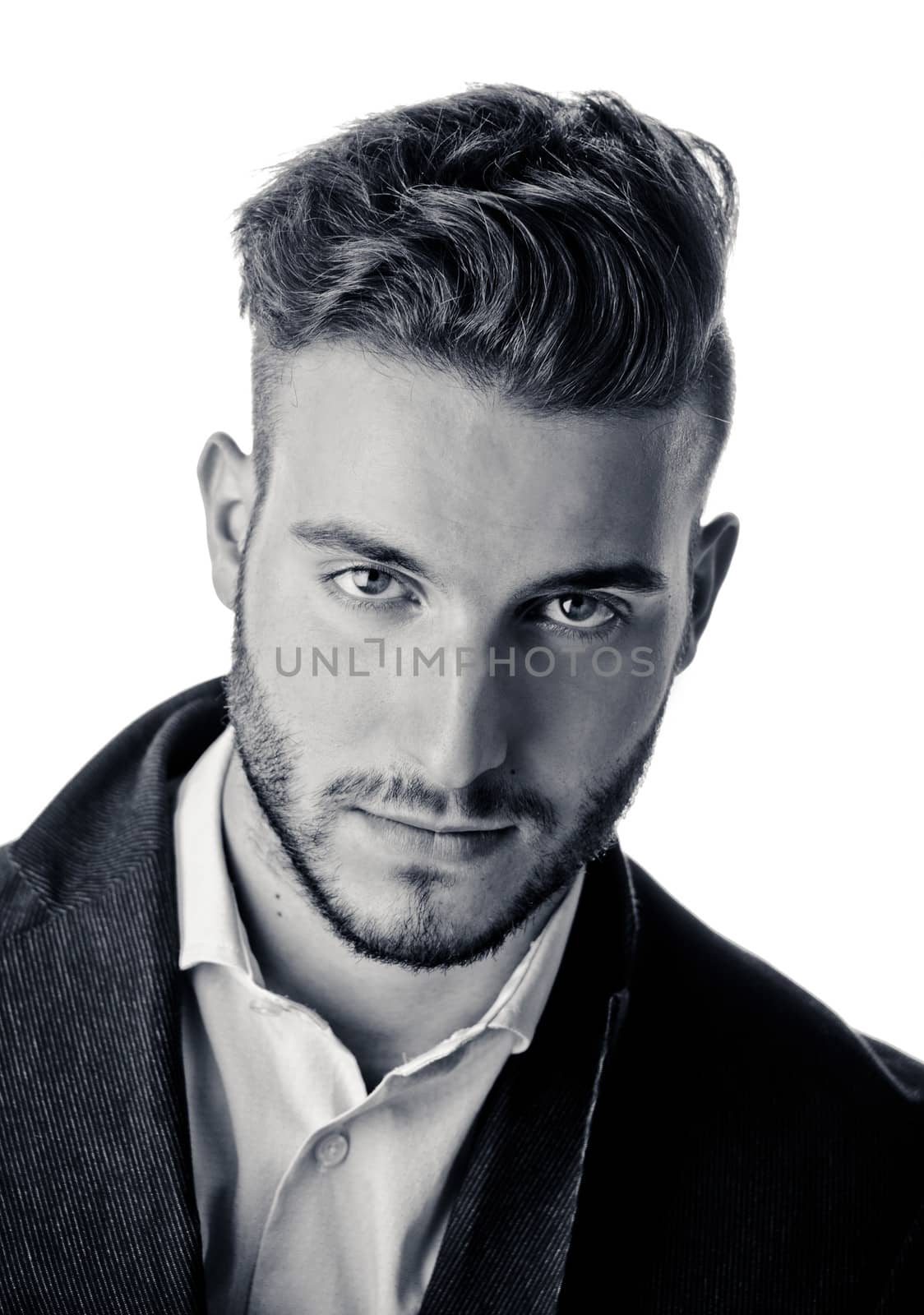 Portrait of handsome young man looking in camera, black and white shot