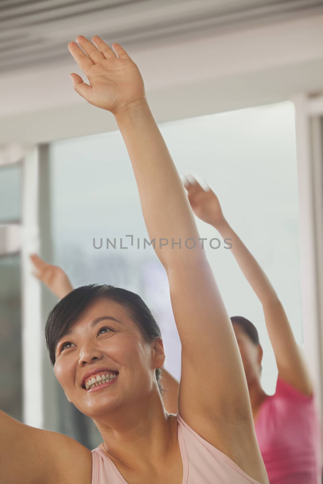 Mature women exercising in the gym by XiXinXing