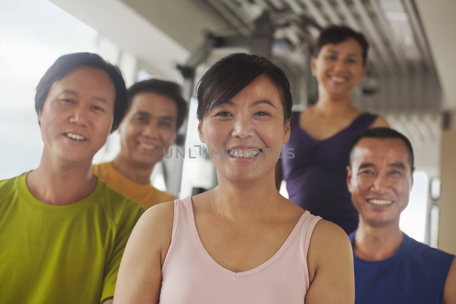 Group of people exercising in the gym, portrait