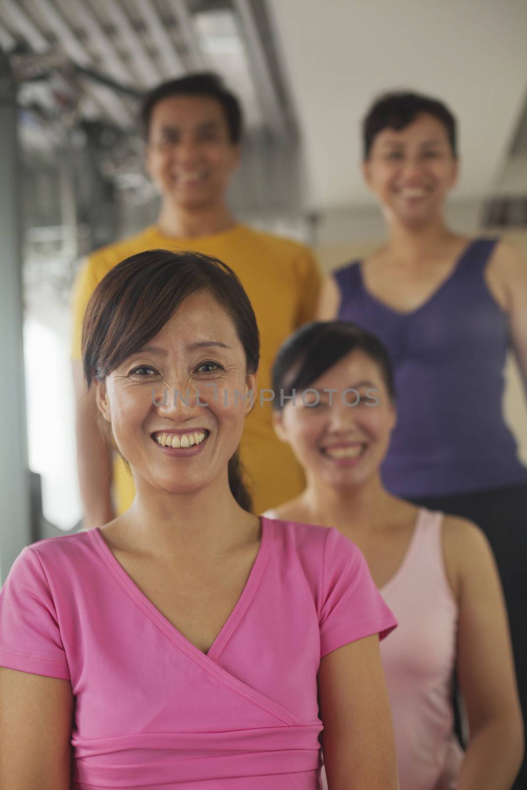 Group of people exercising in the gym, portrait