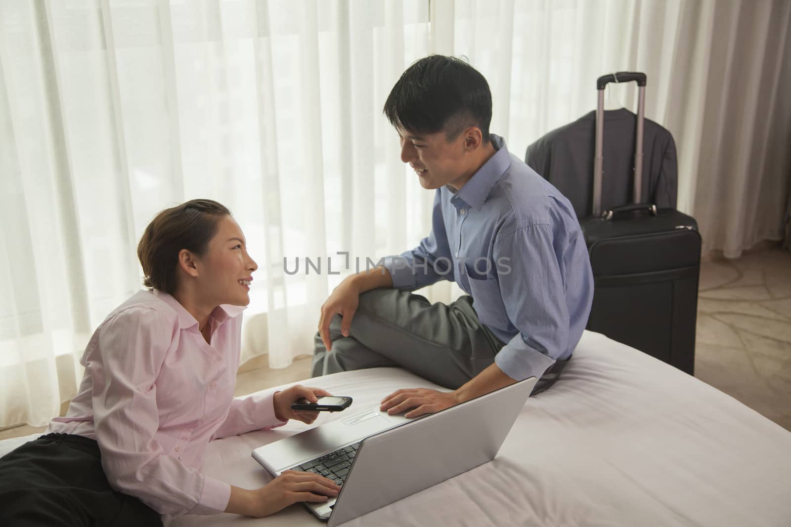 Business couple in hotel room by XiXinXing