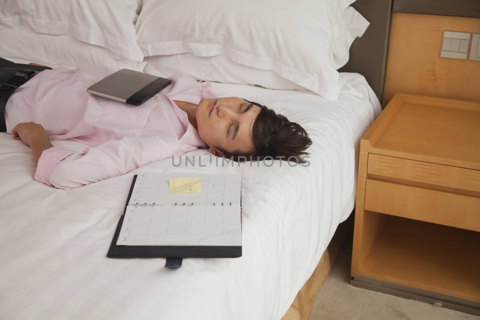Overworked businessman sleeping in his bed