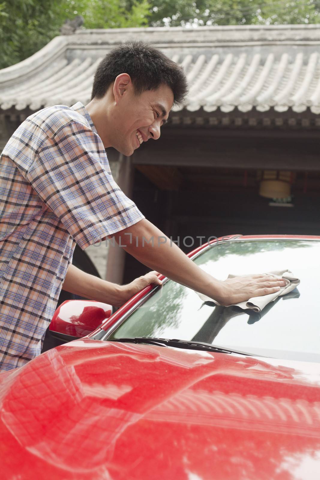 Young Man Cleaning His Car