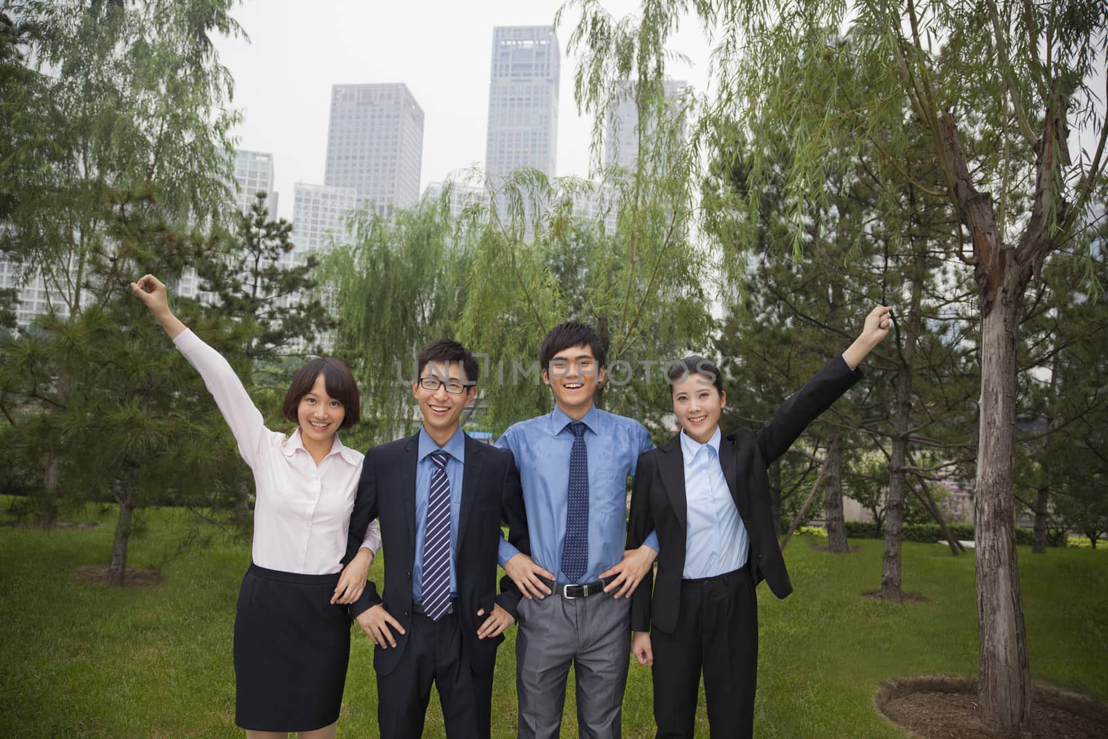 Young business people in the park, portrait by XiXinXing