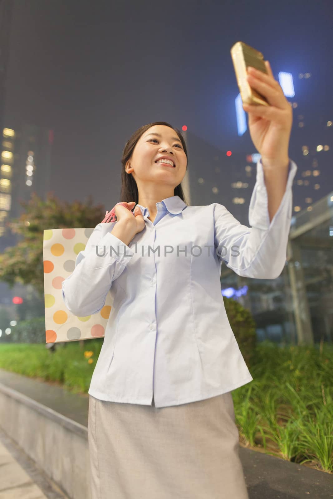Young businesswoman taking a picture of her self with her cell phone