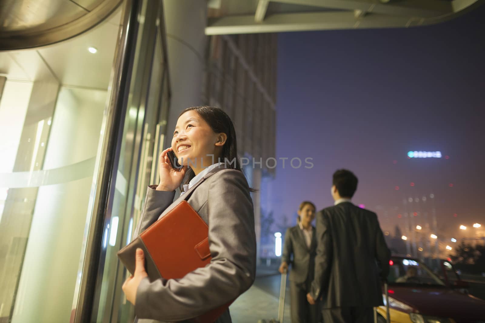 Young businesswoman walking and talking on her cell phone