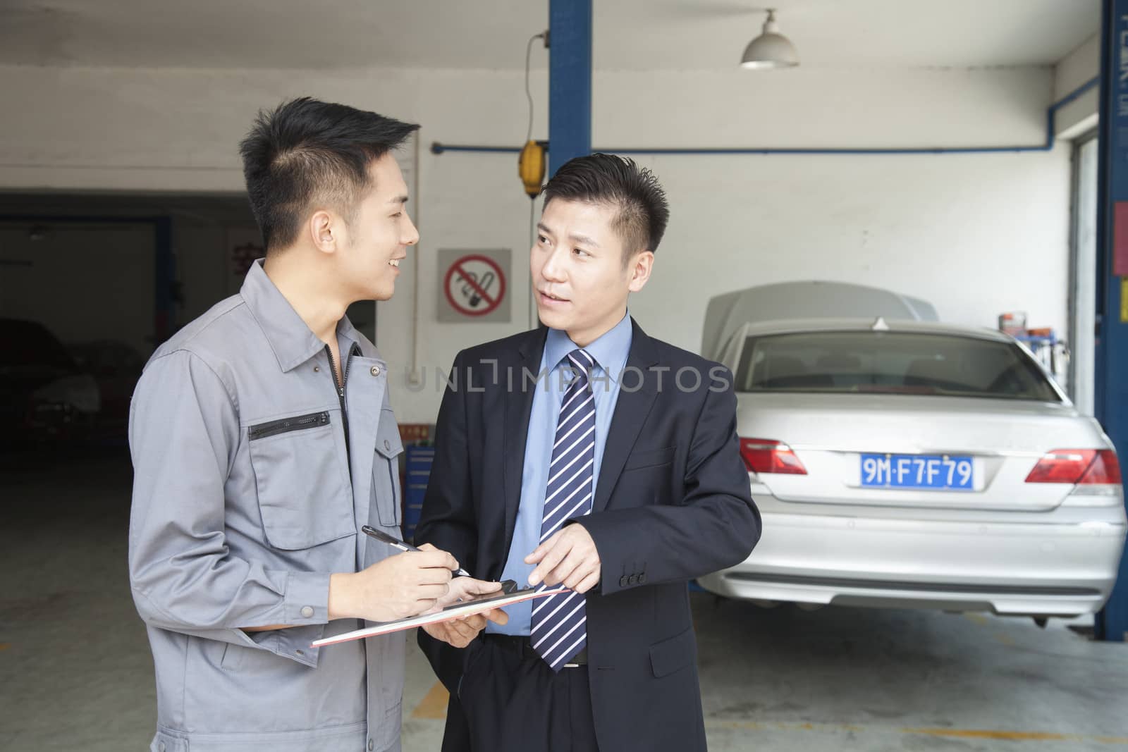 Garage Mechanic Explaining to Customer by XiXinXing