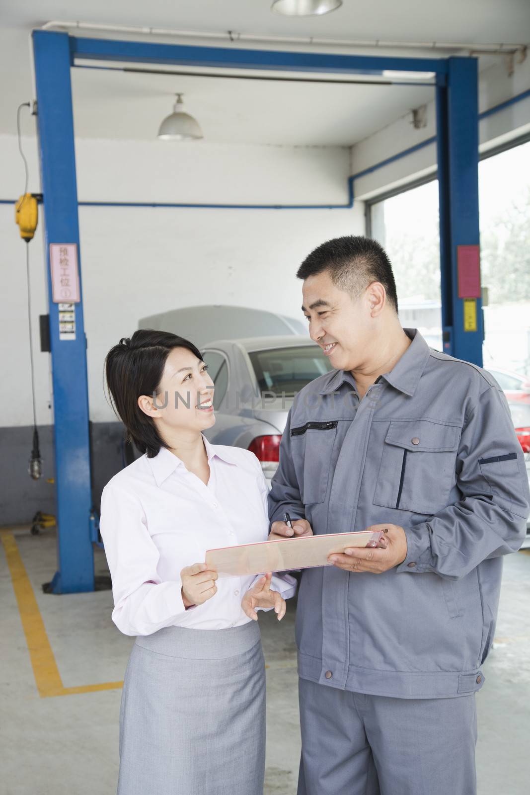 Garage Mechanic Explaining to Customer by XiXinXing