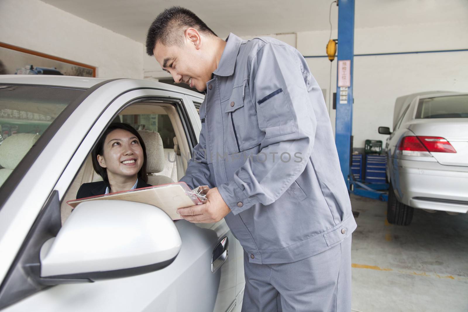 Mechanic Explaining to Businesswoman by XiXinXing