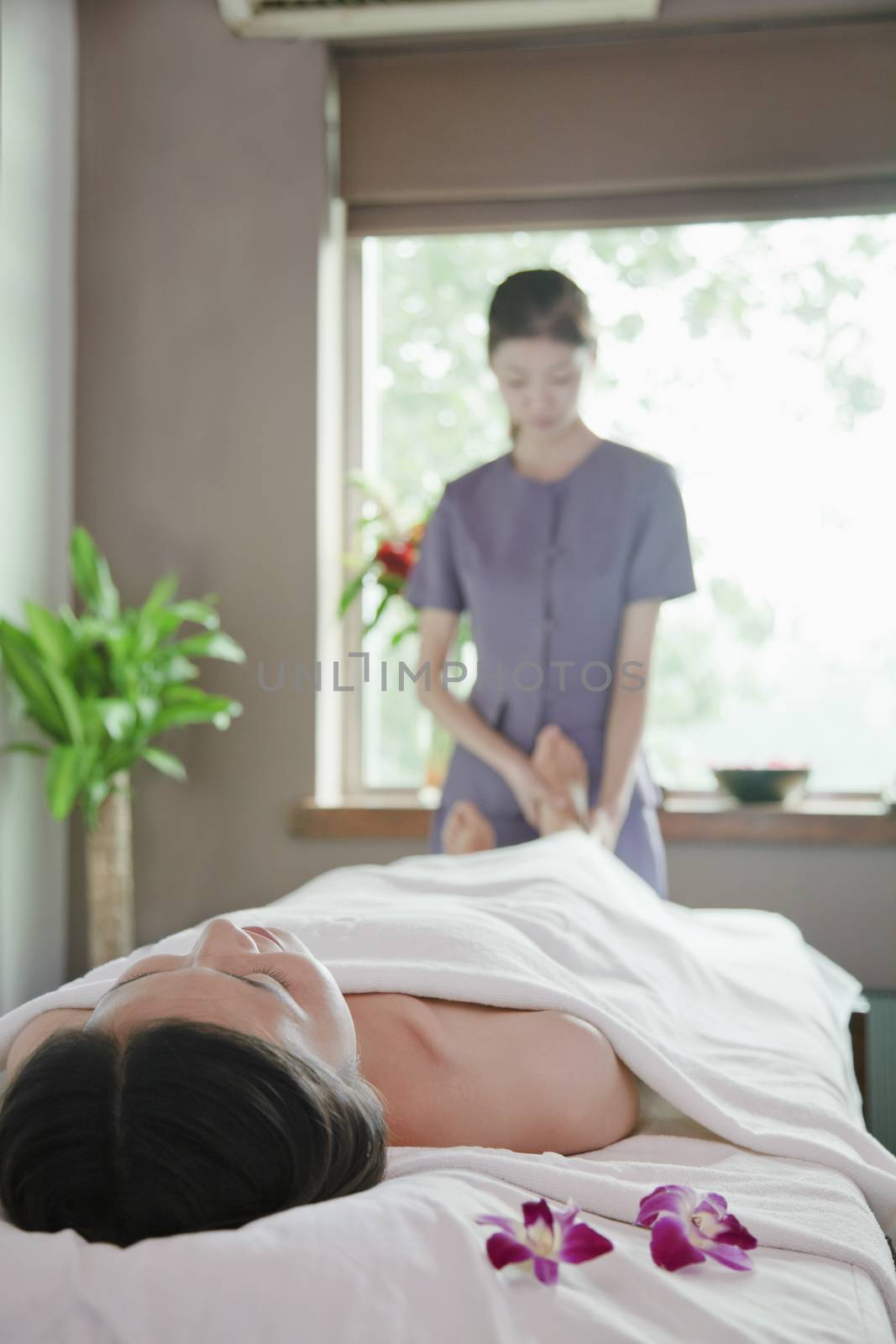Woman Receiving Foot Massage by XiXinXing