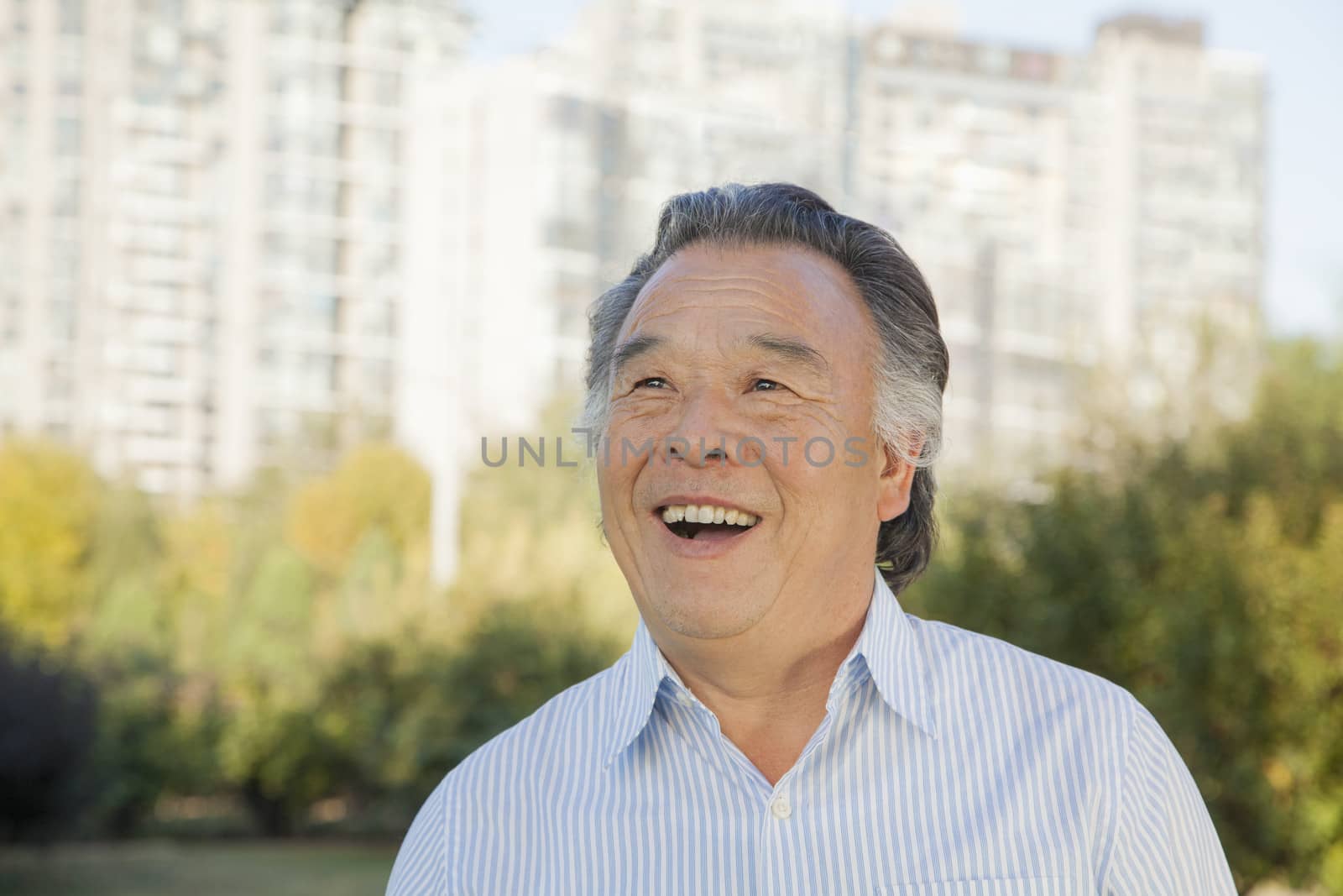 Senior man looking at the sky, portrait