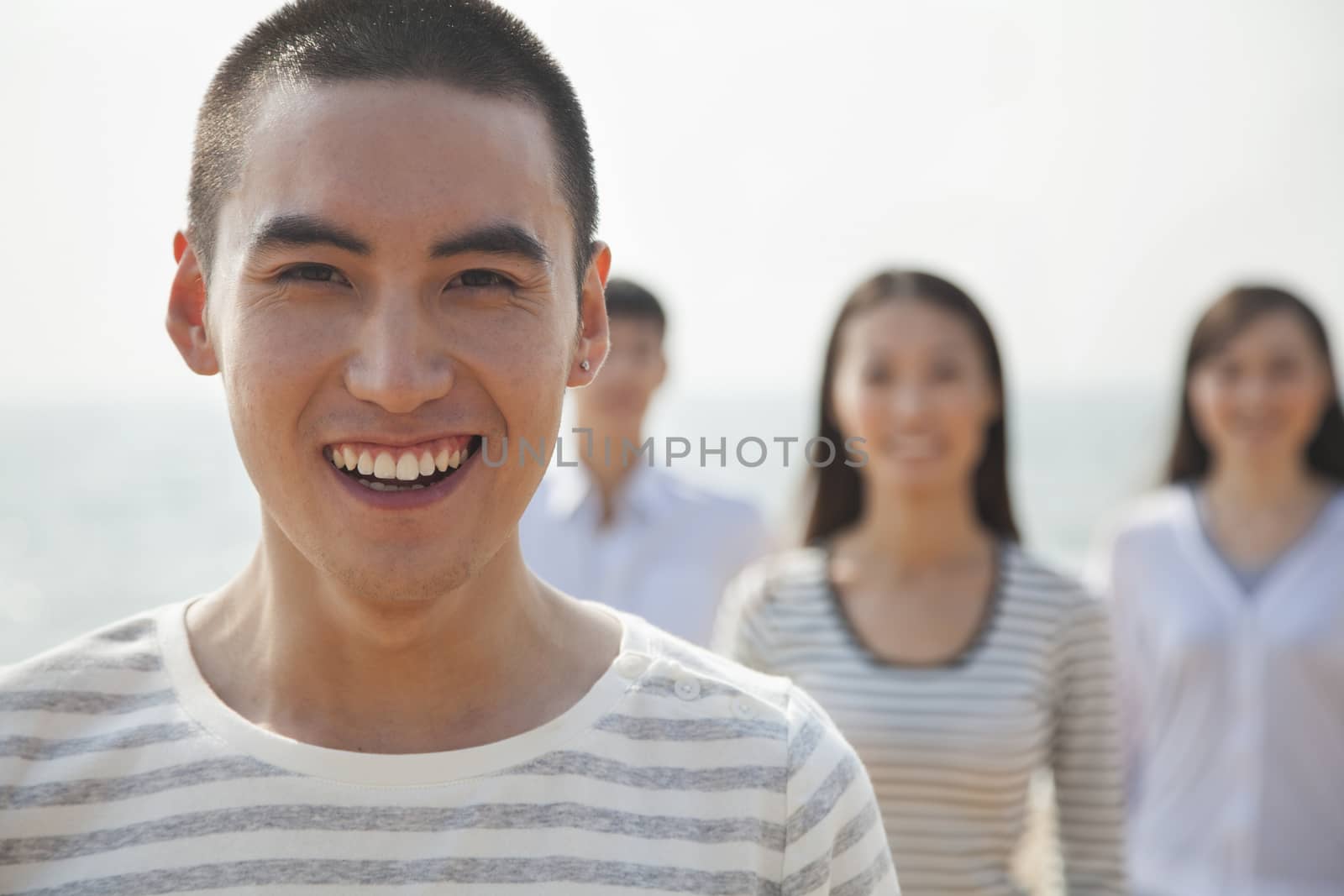 Portrait of Young Man and Friends at Beach by XiXinXing