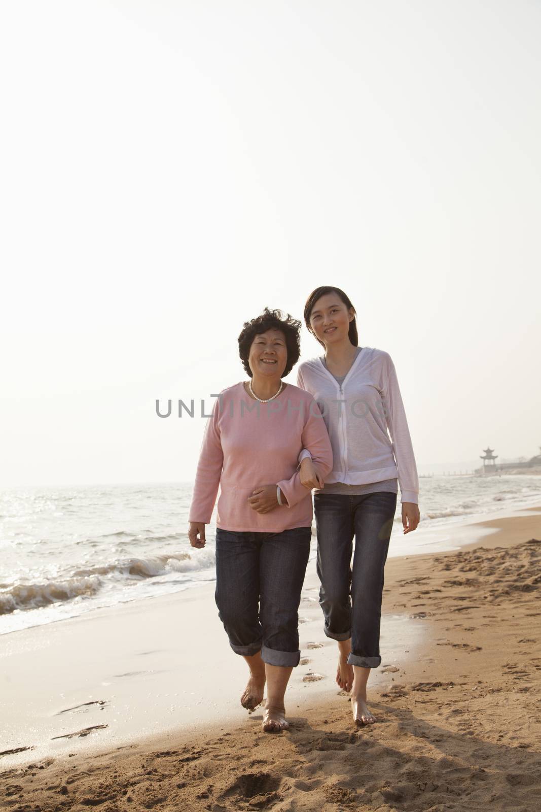 Grandmother and Granddaughter Taking a Walk by the Beach
