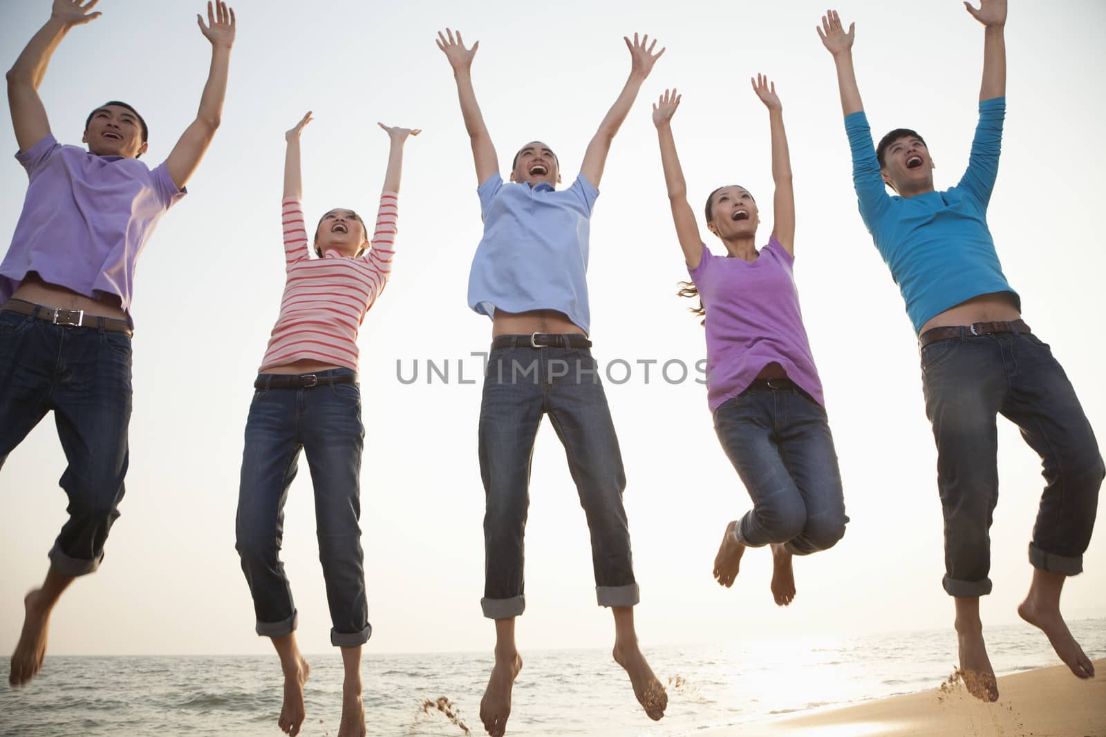 Group of Friends Jumping at the Beach