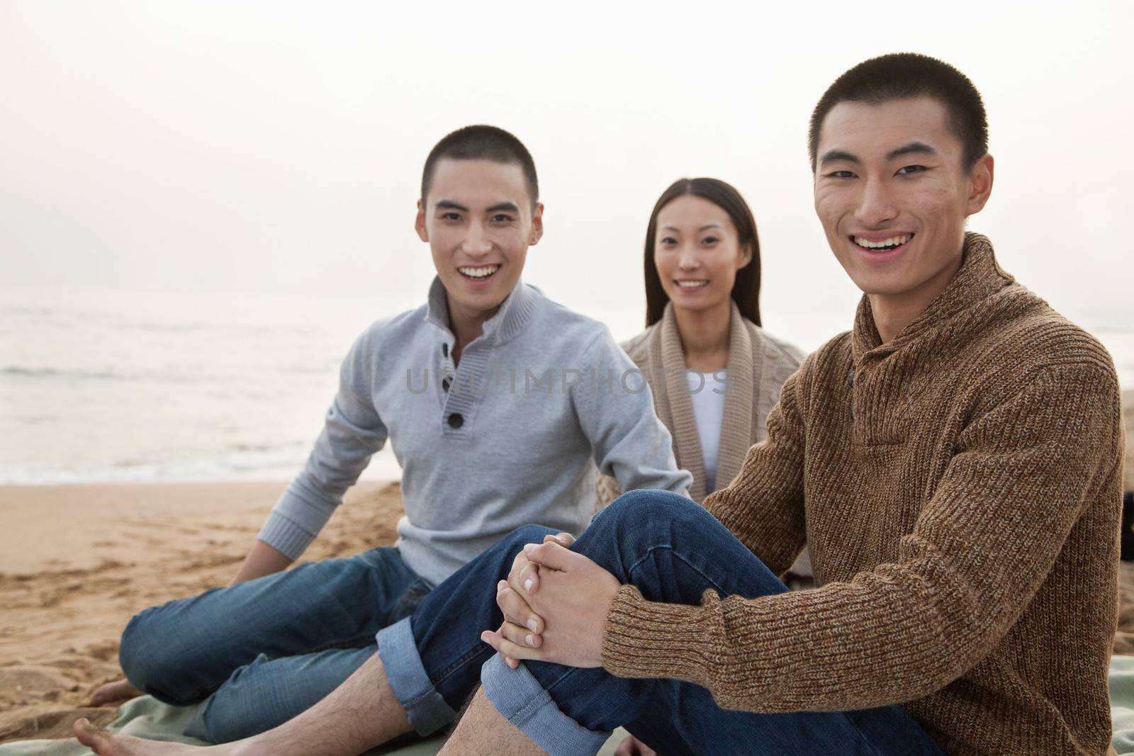 Young Friends Sitting on the Beach