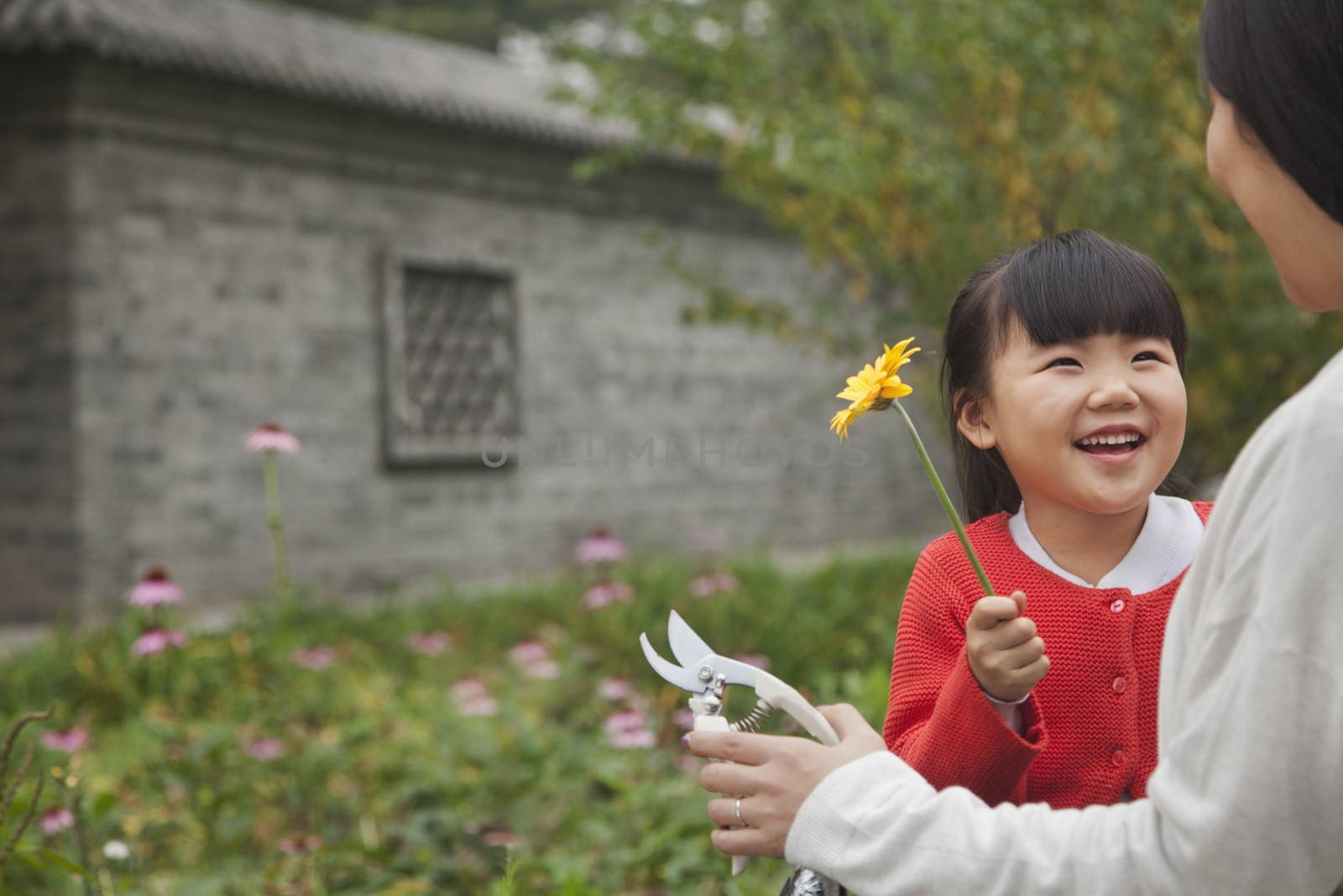 Smiling young girl with flower