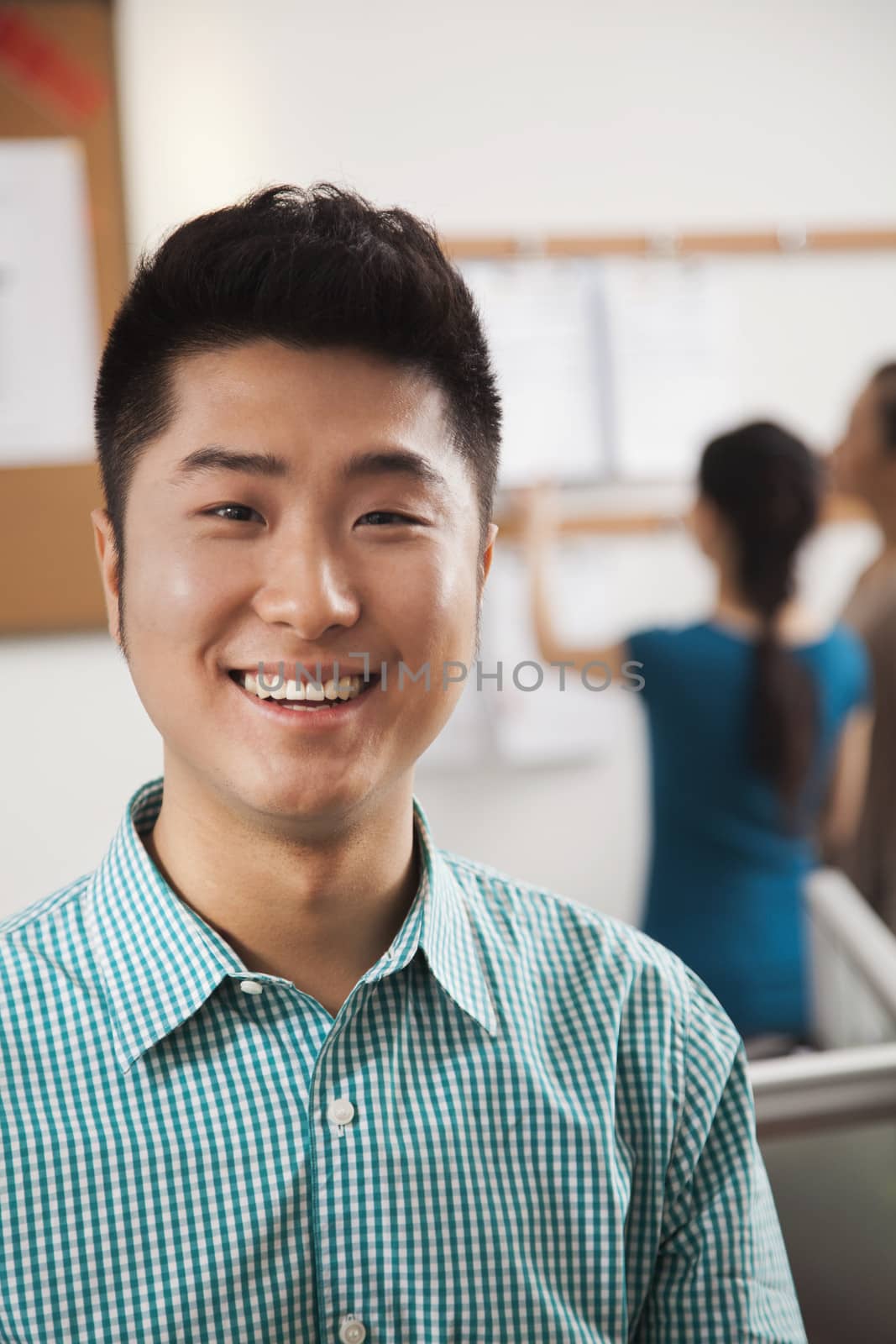 Portrait of young businessman in the office by XiXinXing
