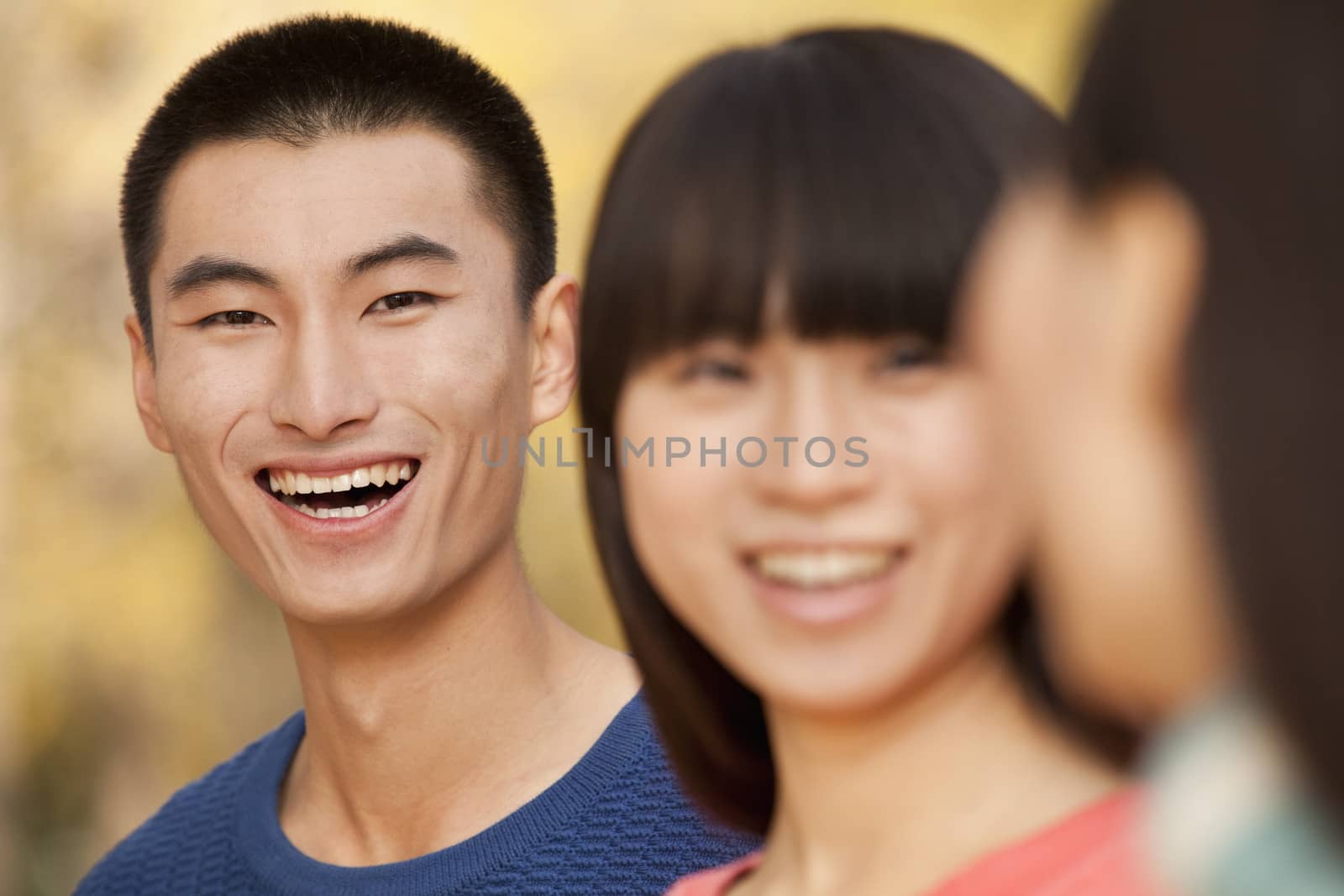 Young people enjoying a park in autumn by XiXinXing