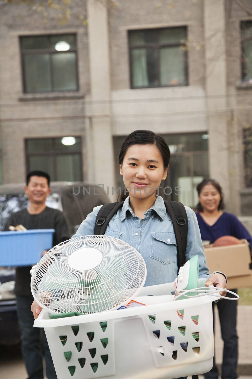 Student portrait in front of dormitory at college with family by XiXinXing