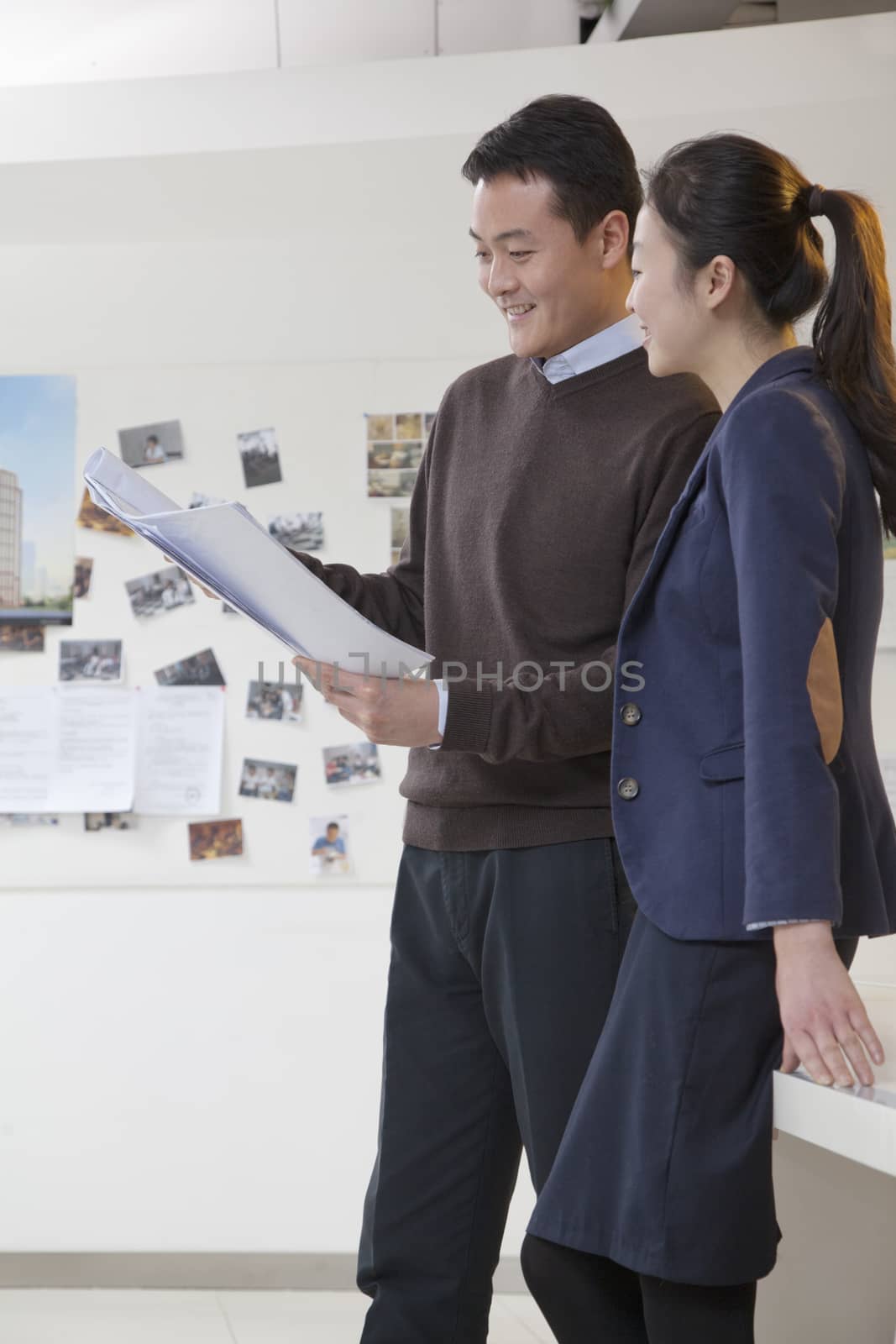 Coworkers discussing project in the office