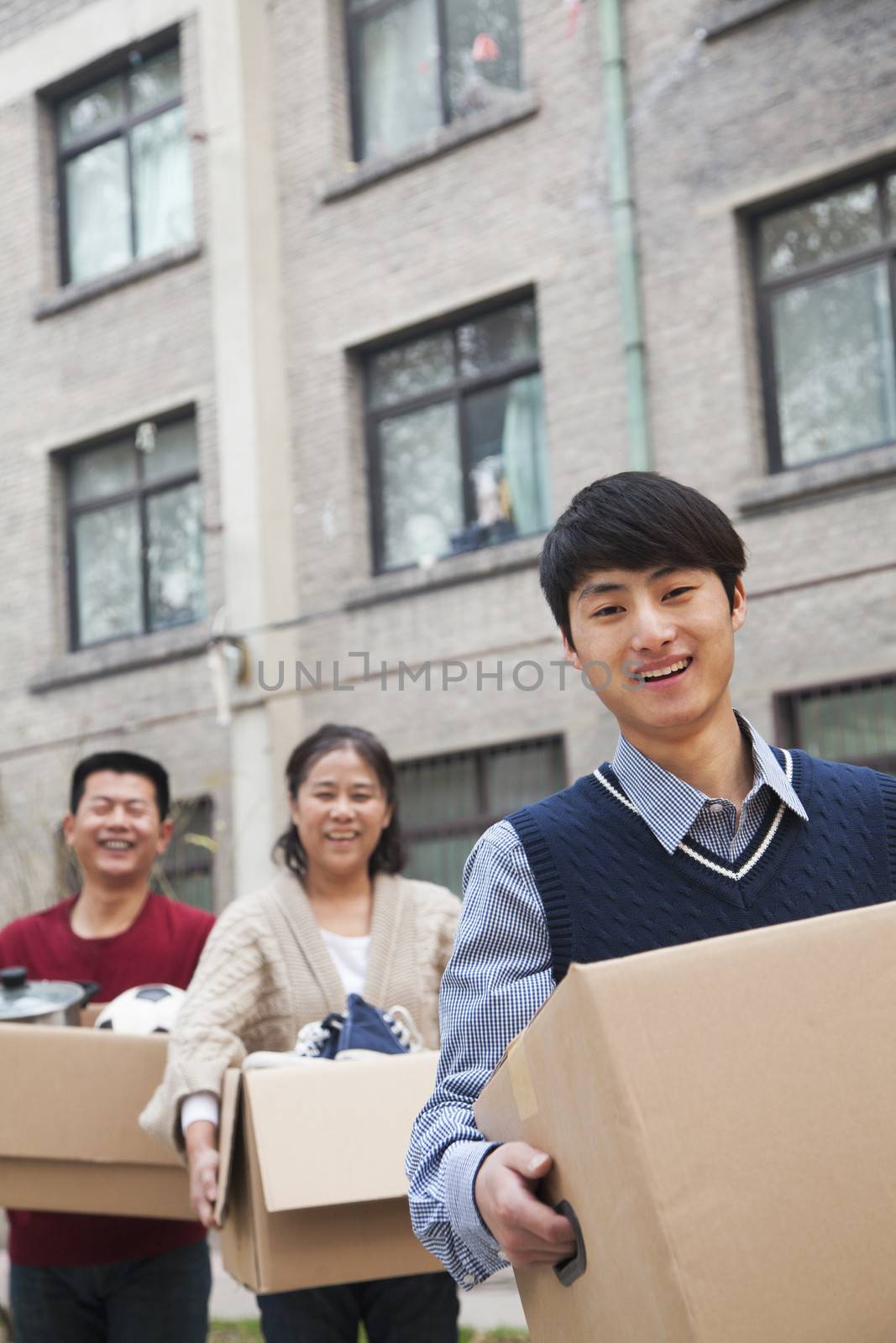 Family moving boxes into a dormitory at college by XiXinXing