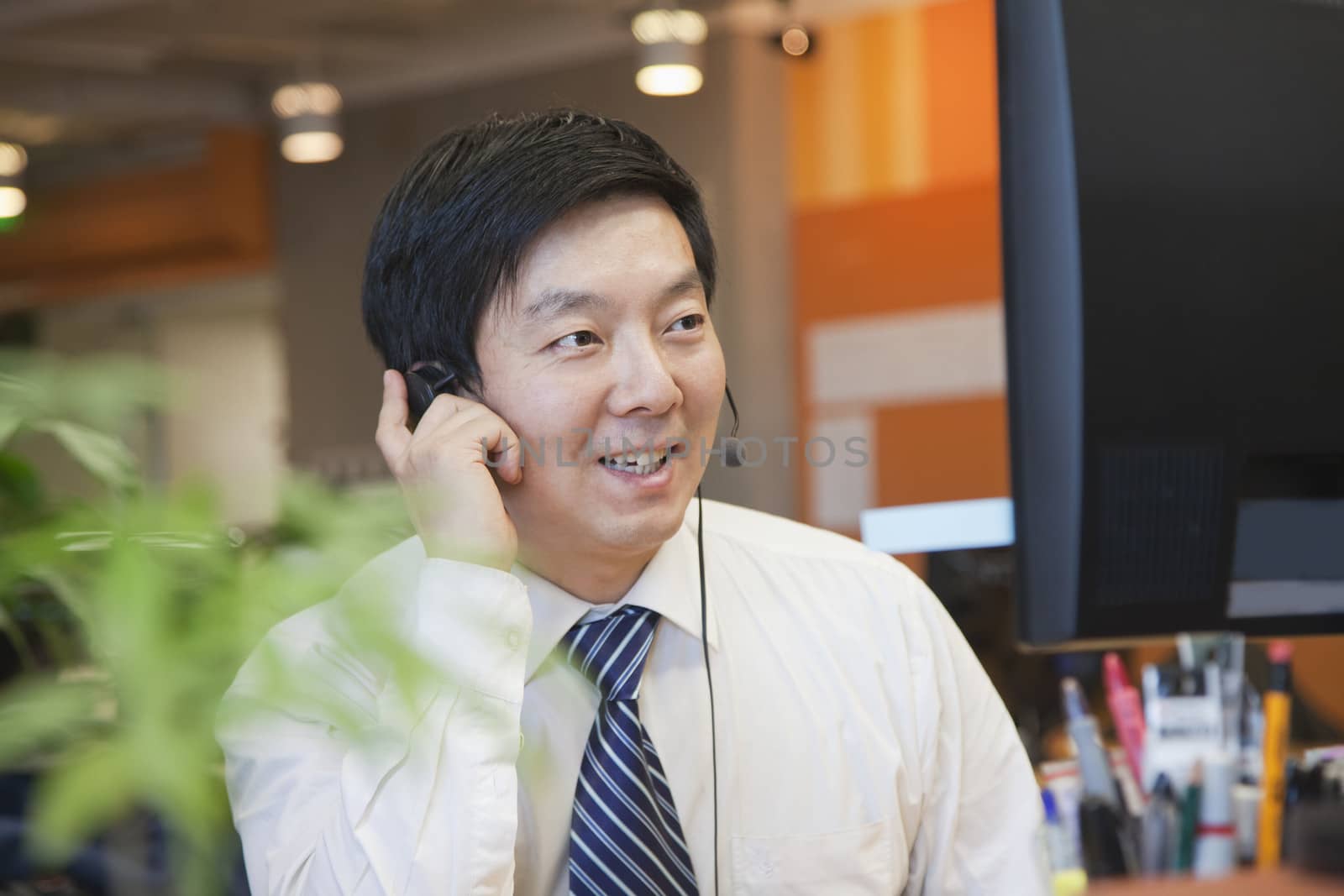 Businessman Wearing Headset in the Office