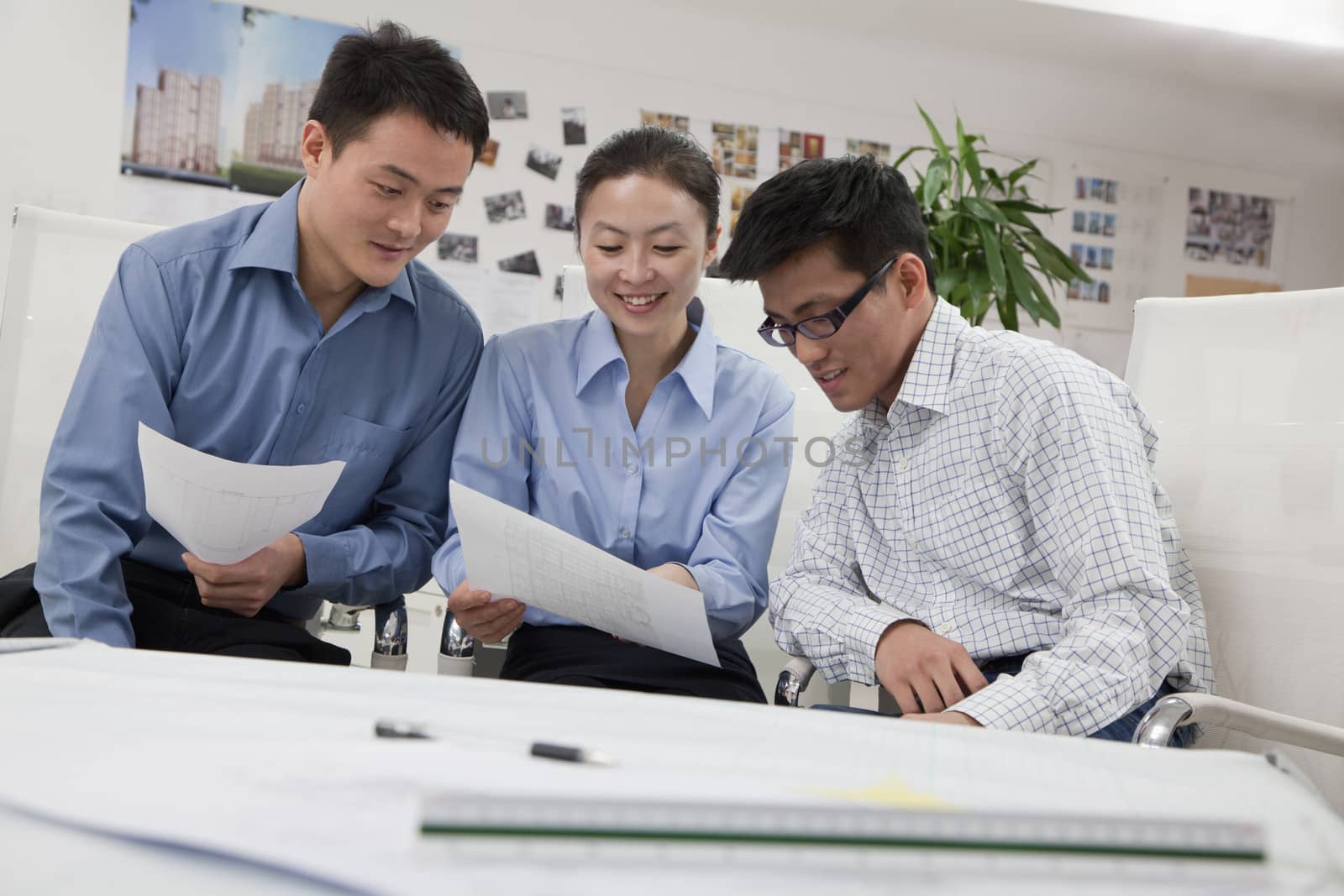 Coworkers discussing project in the office