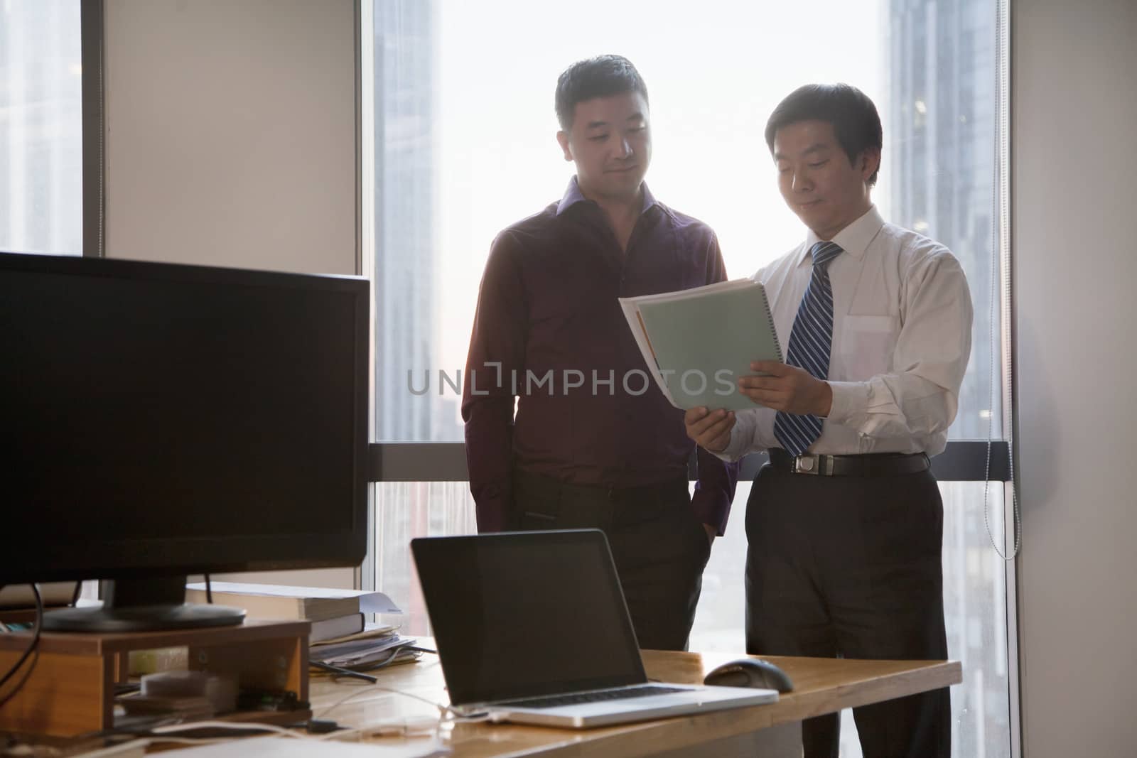 Two Businessmen Working Together in the Office