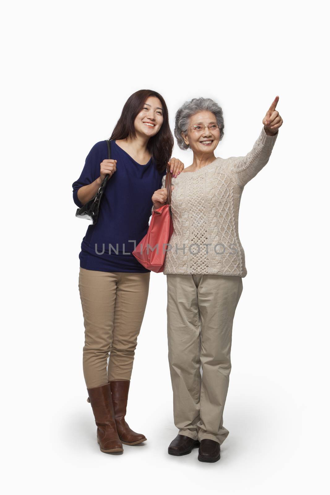 Senior mother and daughter pointing