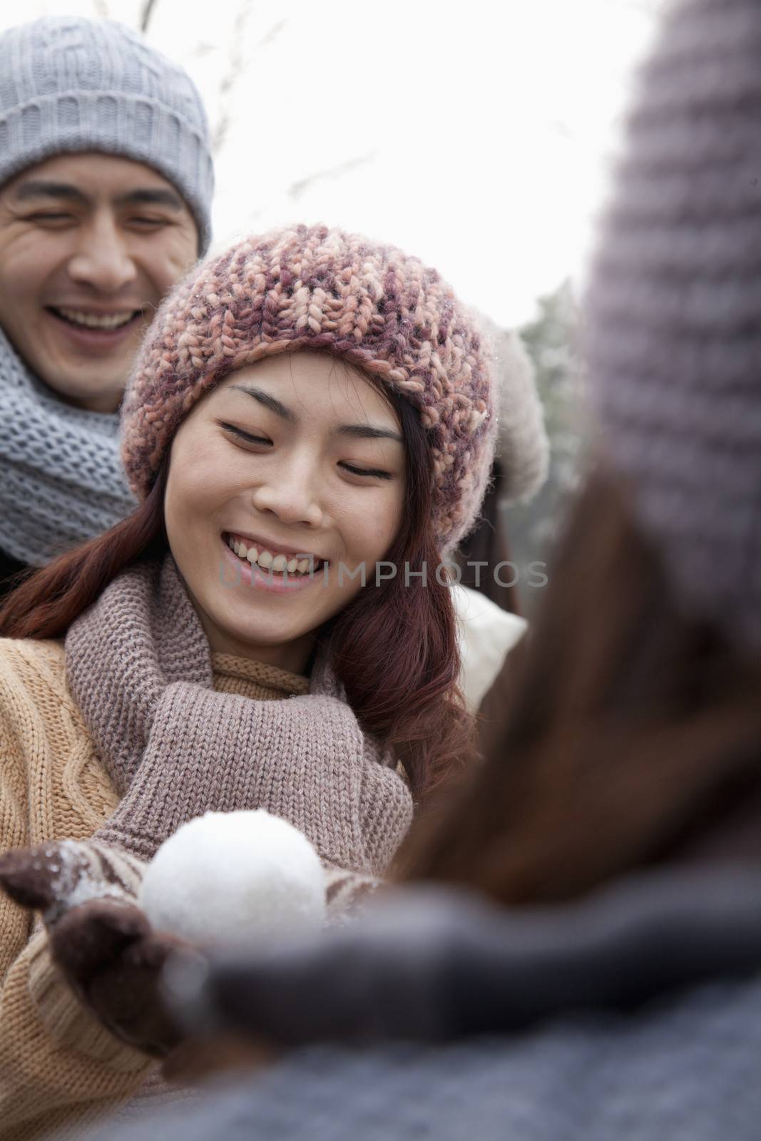 Young Woman Holding a Snowball by XiXinXing
