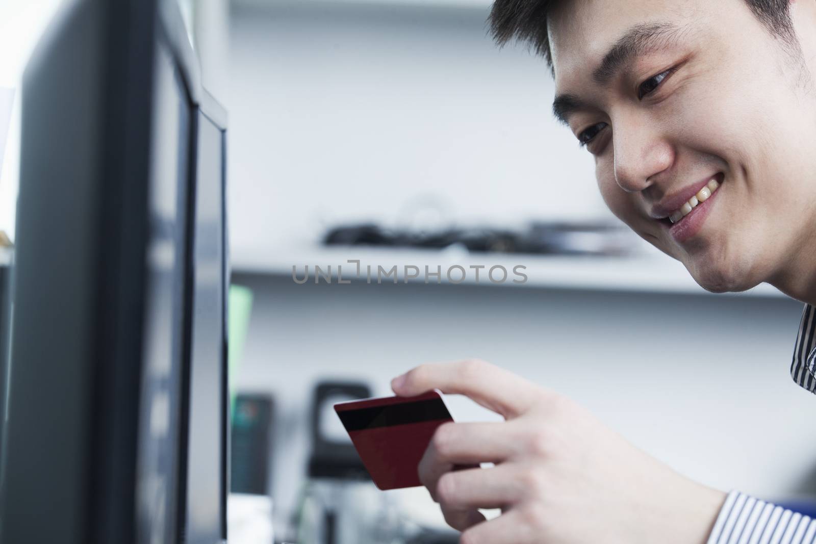 Businessman holding card in office