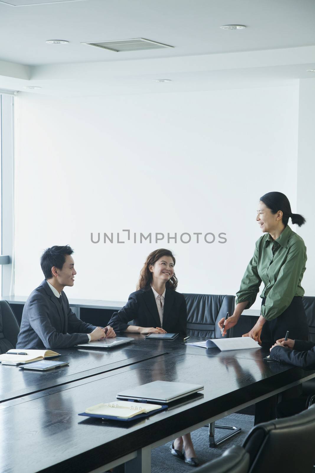 Co-workers in meeting room by XiXinXing