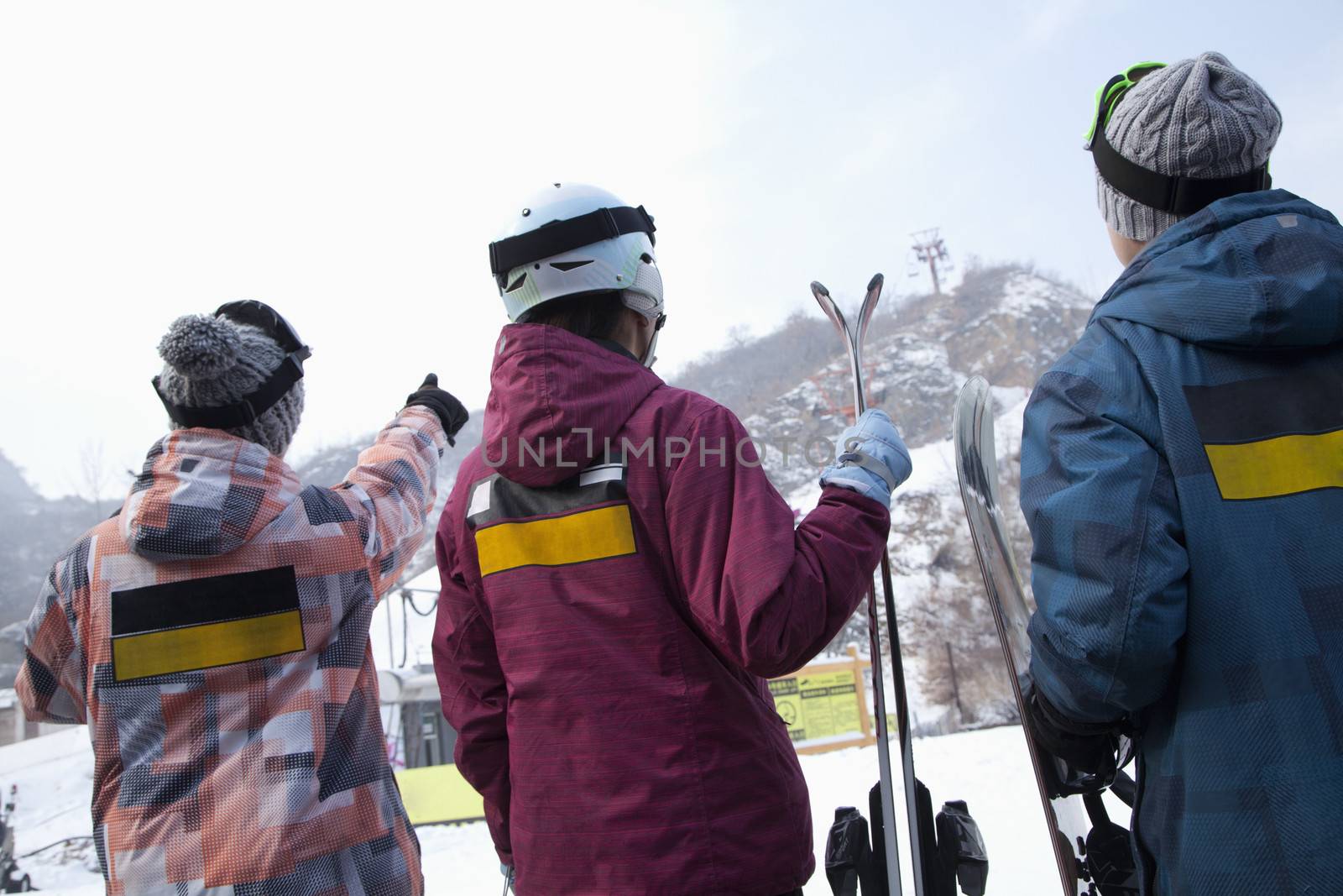 Group of People Pointing at Hill in Ski Resort by XiXinXing