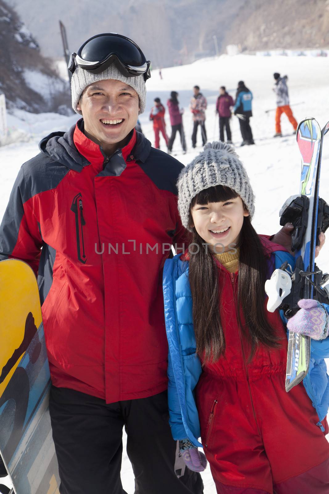 Smiling Father and Daughter in Ski Resort, portrait by XiXinXing