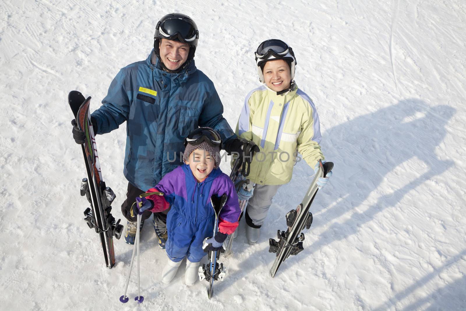 Smiling Family with Ski Gear in Ski Resort by XiXinXing