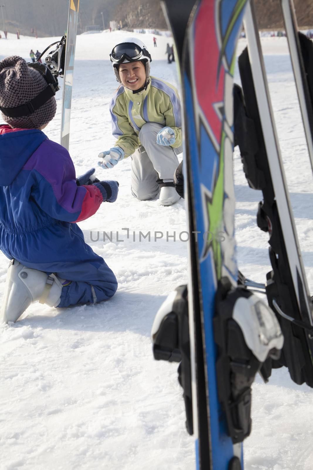 Smiling Family with Ski Gear in Ski Resort by XiXinXing
