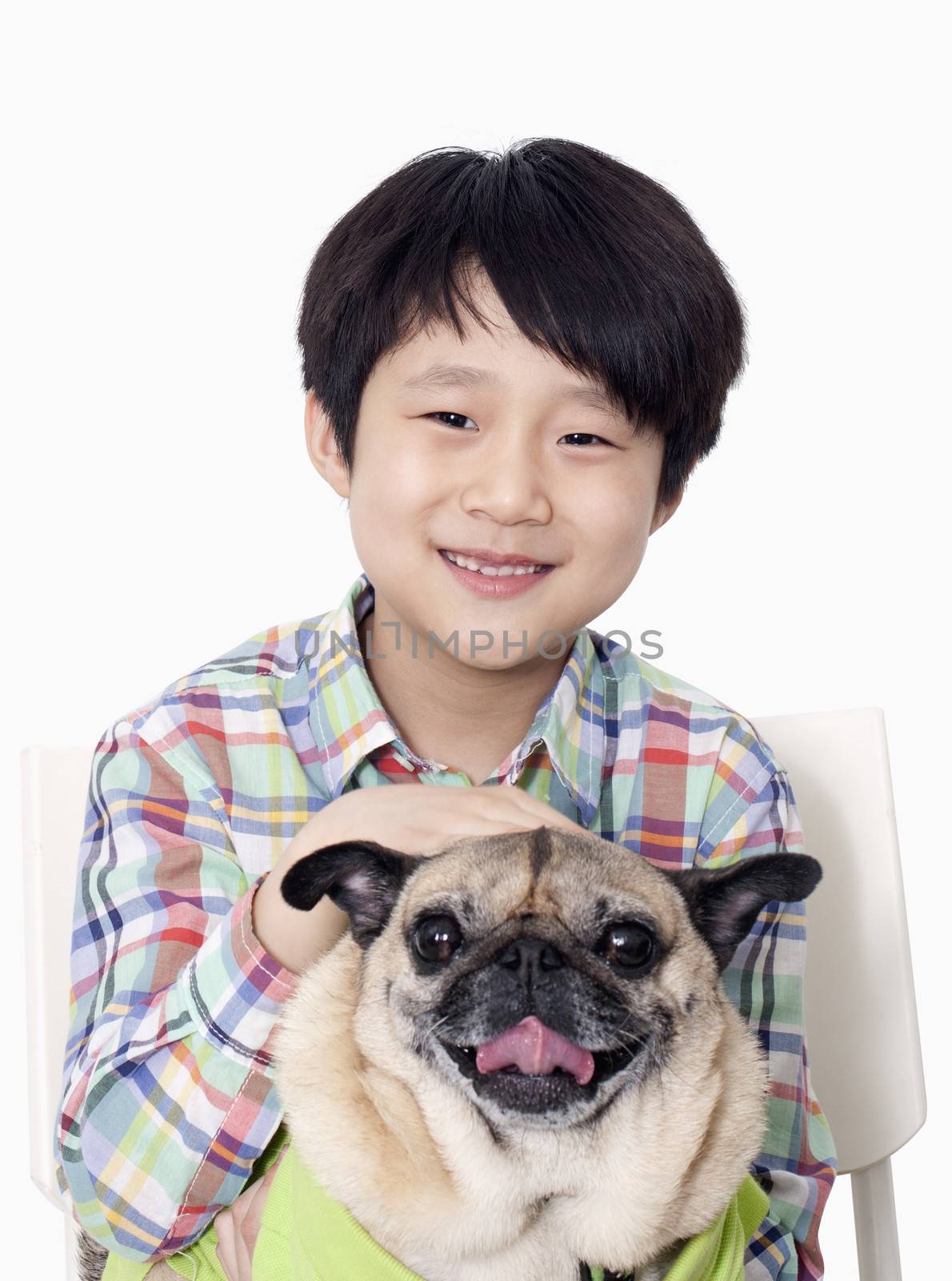 Portrait of Boy holding pet pug