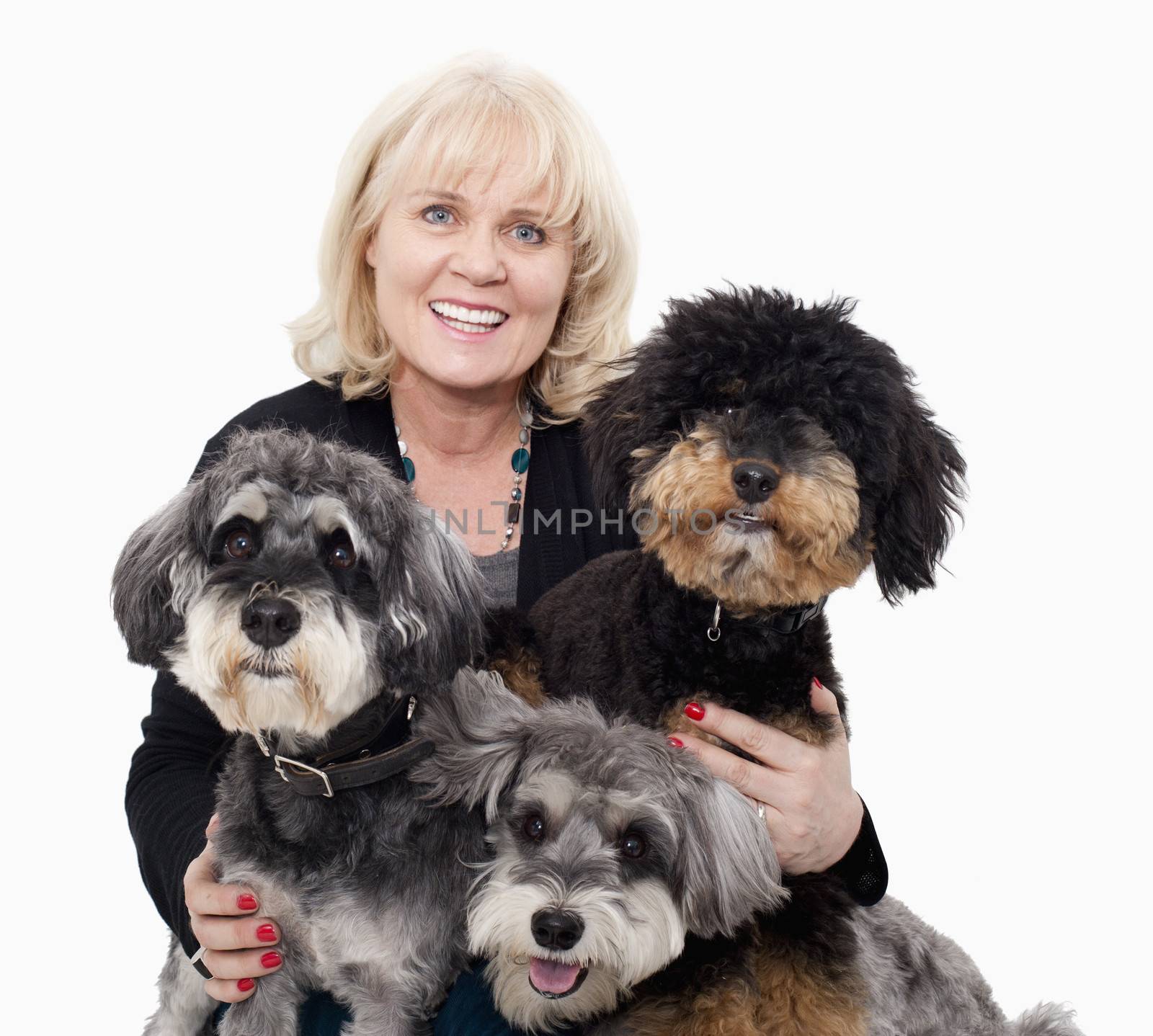 Portrait of woman embracing her dogs, studio shot by XiXinXing