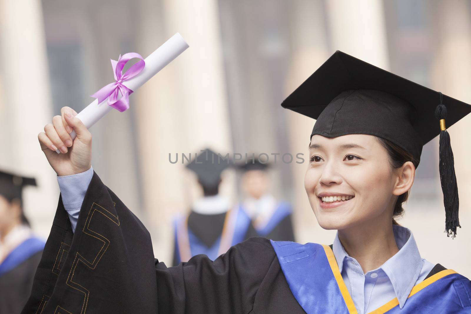 Young Female Graduate Smiling and Holding Diploma by XiXinXing