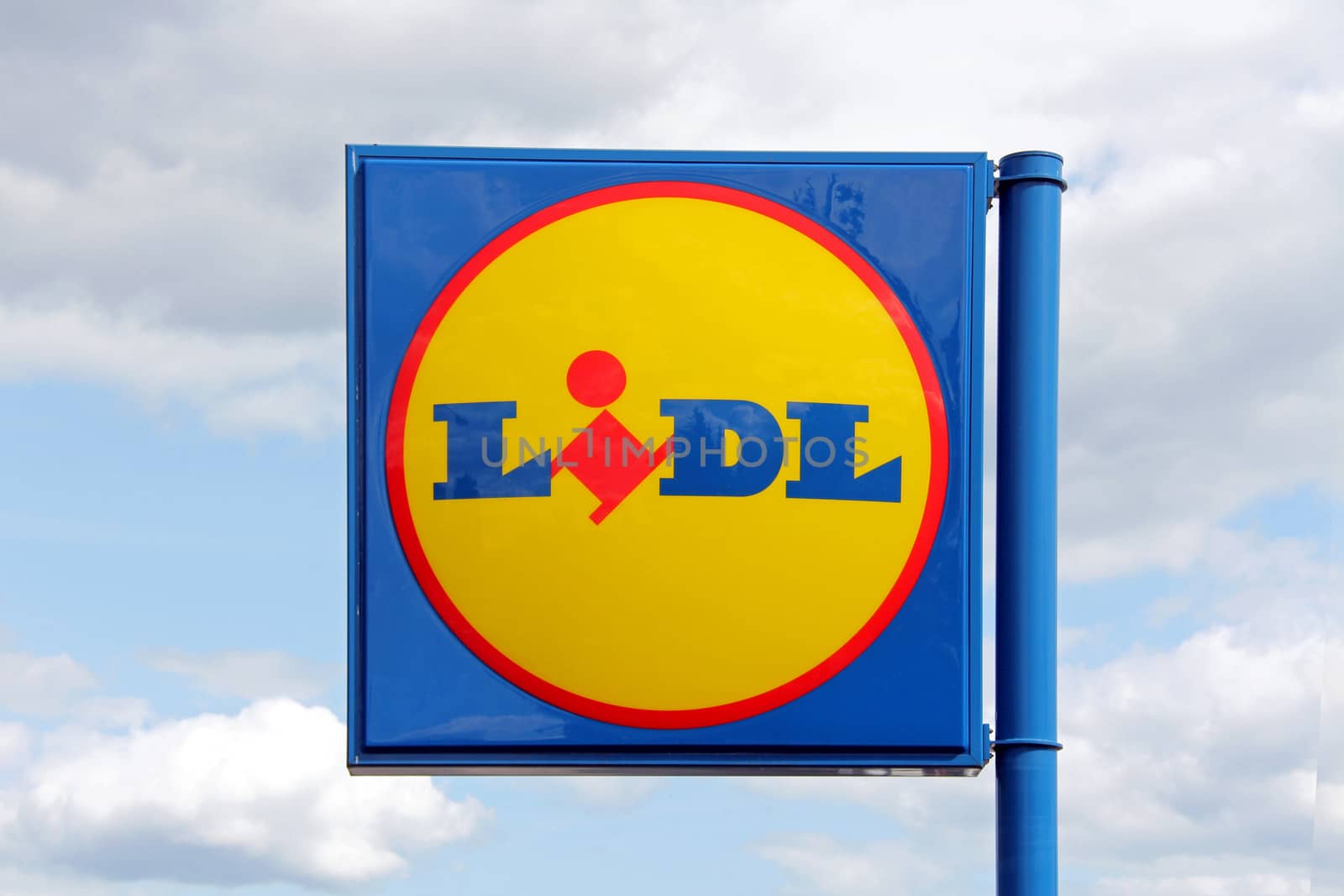 KARKKILA, FINLAND - JULY 13, 2013: Sign Lidl against sky in Karkkila, Finland on July 13, 2013. Lidl Stiftung & Co. KG  is a German global discount supermarket chain, that operates over 10,000 stores across Europe.