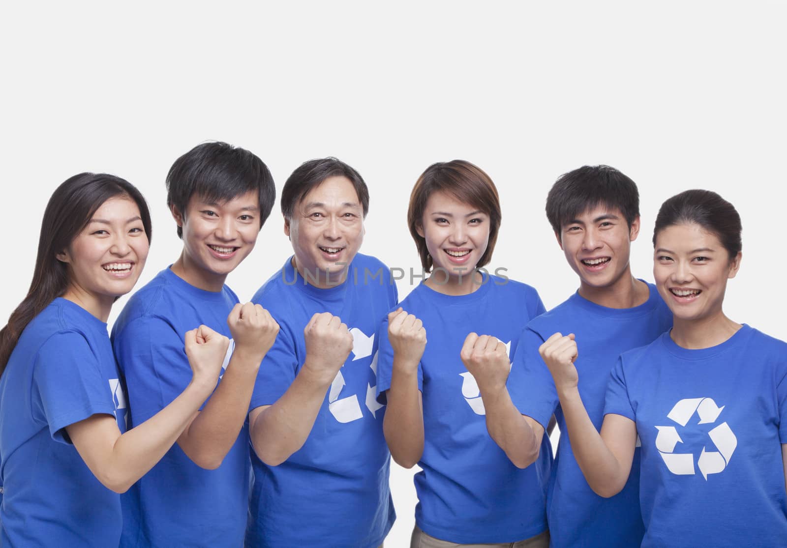 Group of people with raised fists, studio shot by XiXinXing