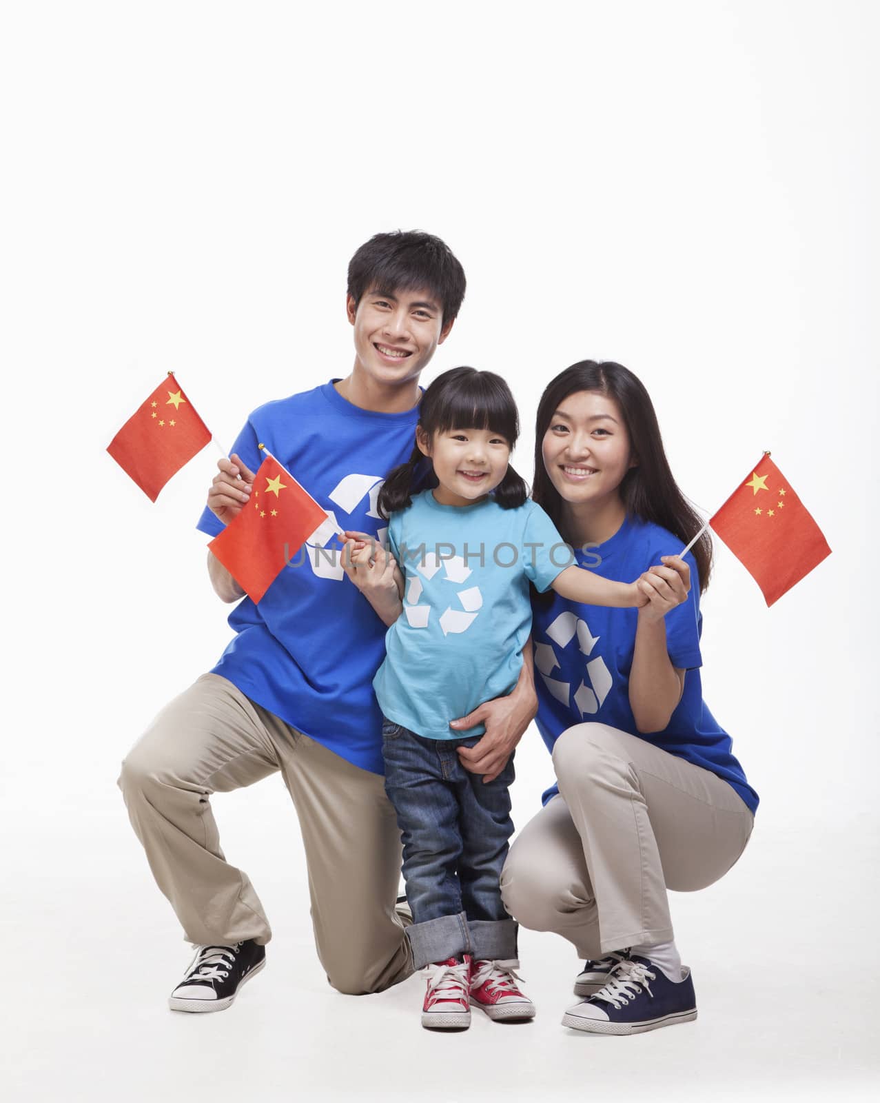 Family Portrait, one child with parents, waving Chinese flags, studio shot by XiXinXing