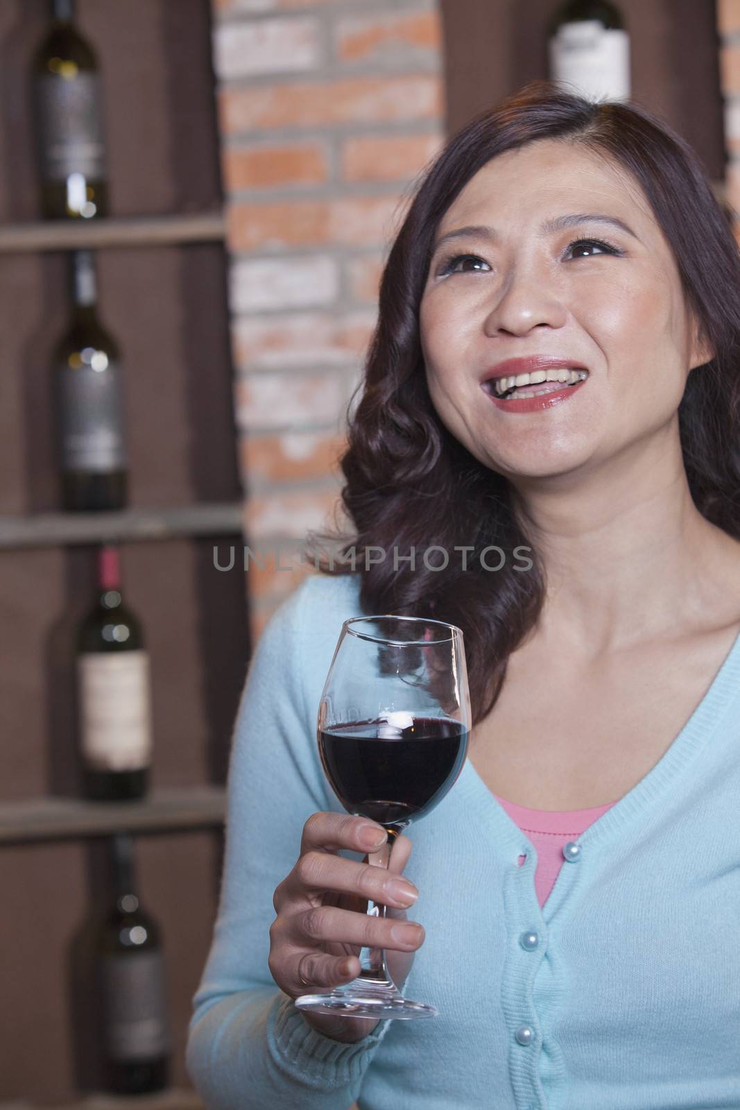 Mature Woman Enjoying a Glass of Wine