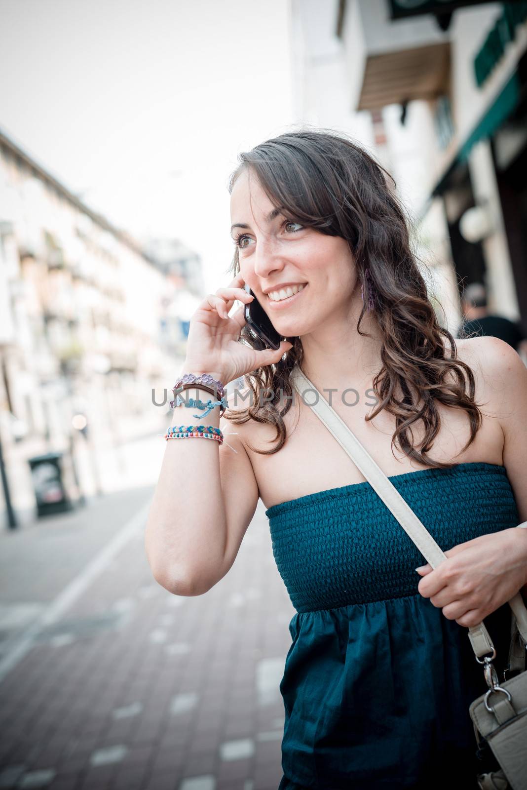 beautiful woman on the phone walking in the city